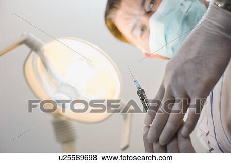 Doctor preparing shot for patient View Large Photo Image Stock Photo - Doctor preparing shot for patient. Fotosearch