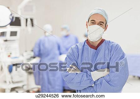 Doctor standing in operating room View Large Photo Image Stock Photograph - Doctor standing in operating room. Fotosearch