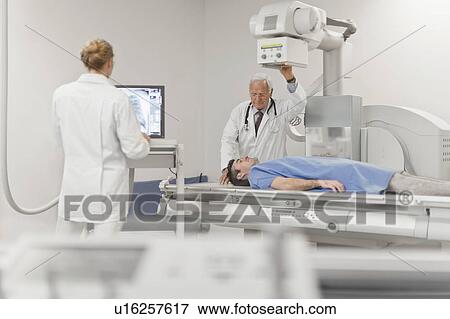Stock Photo - Doctors taking x-rays of patient. Fotosearch
