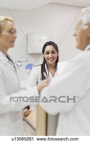 Doctors talking in hospital View Large Photo Image Stock Image - Doctors talking in hospital. Fotosearch