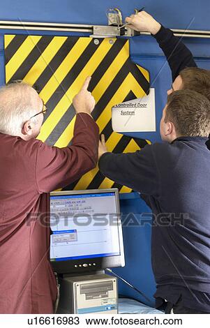 Electrical engineers working in shop View Large Photo Image Stock Image - Electrical engineers working in shop. Fotosearch