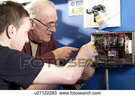Electrical engineers working in shop View Large Photo Image Stock Image - Electrical engineers working in shop. Fotosearch