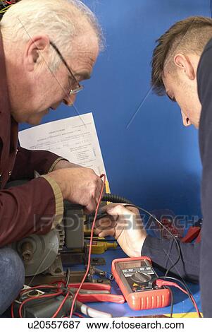 Electrical engineers working in shop View Large Photo Image Stock Photo - Electrical engineers working in shop. Fotosearch