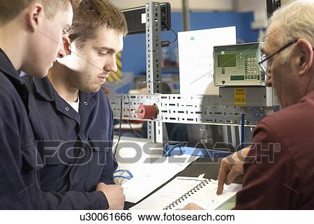 Stock Photograph - Electrical engineers working in shop. Fotosearch