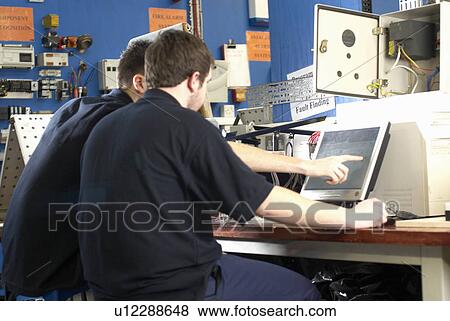 Electrical engineers working on computer View Large Photo Image Stock Photo - Electrical engineers working on computer. Fotosearch
