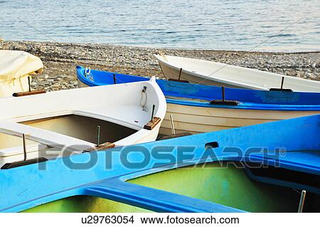 Empty canoes on rocky beach View Large Photo Image Picture - Empty canoes on rocky beach. Fotosearch