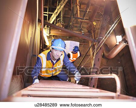 Engineer climbing staircase in ship View Large Photo Image Stock Photo - Engineer climbing staircase in ship. Fotosearch