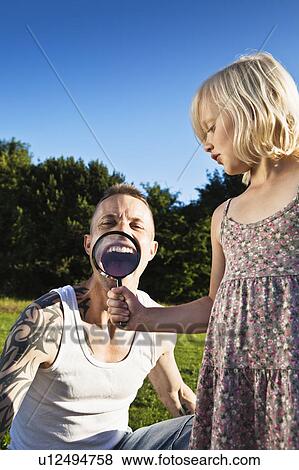 Stock Photo - Father and daughter playing outdoors. Fotosearch