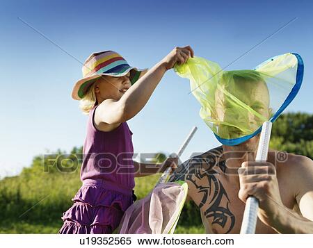 Father and daughter playing with nets View Large Photo Image Stock Photography - Father and daughter playing with nets. Fotosearch