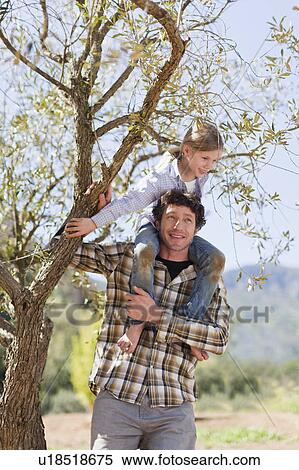 Father carrying daughter on shoulders View Large Photo Image Stock Photography - Father carrying daughter on shoulders. Fotosearch