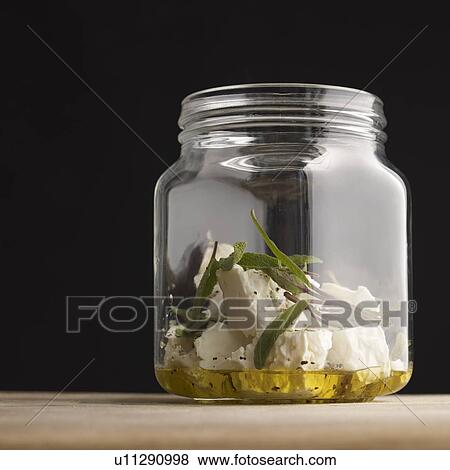Feta marinating in herbs and olive oil View Large Photo Image Stock Photo - Feta marinating in herbs and olive oil. Fotosearch