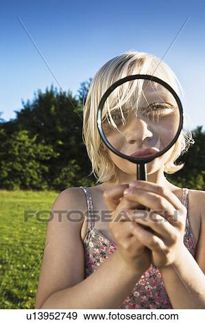 Stock Photo - Girl playing with magnifying glass. Fotosearch