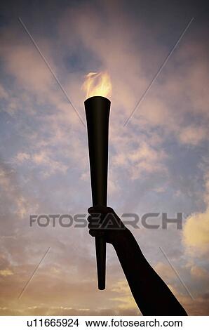 Picture - Hand holding flaming baton. Fotosearch