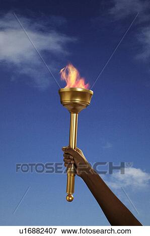 Stock Photo - Hand holding flaming baton. Fotosearch