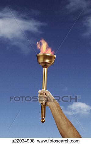 Stock Photo - Hand holding flaming baton. Fotosearch