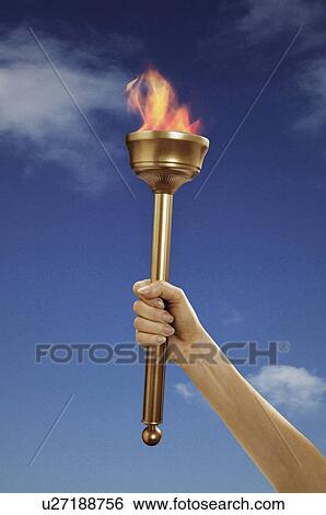 Stock Photograph - Hand holding flaming baton. Fotosearch