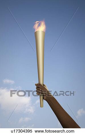 Hand holding flaming baton View Large Photo Image Stock Photography - Hand holding flaming baton. Fotosearch