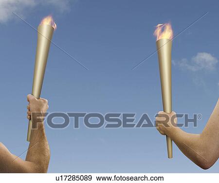 Hands holding flaming batons View Large Photo Image Stock Photo - Hands holding flaming batons. Fotosearch