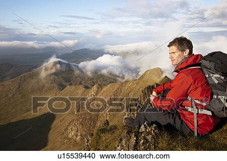 Hiker overlooking view from mountaintop View Large Photo Image Stock Image - Hiker overlooking view from mountaintop. Fotosearch