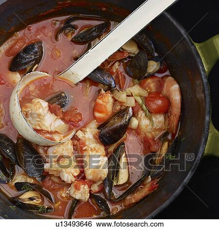 Ladle in pot of fish stew View Large Photo Image Stock Photograph - Ladle in pot of fish stew. Fotosearch