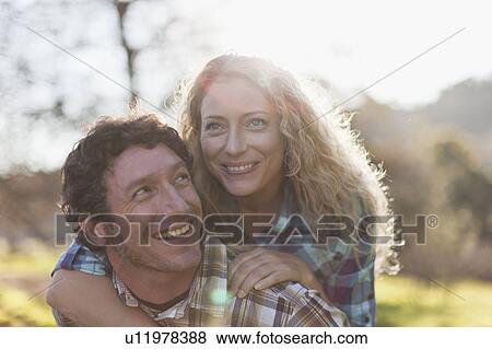 Man carrying girlfriend piggyback View Large Photo Image Stock Photo - Man carrying girlfriend piggyback. Fotosearch