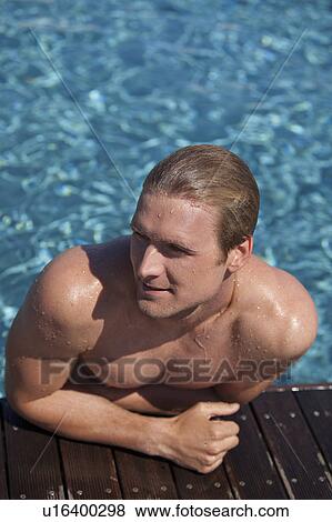 Stock Photo - Man climbing out of swimming pool. Fotosearch