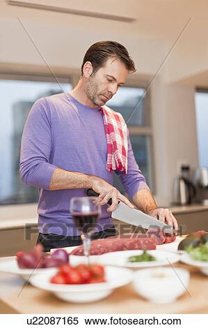 Man cooking dinner in kitchen View Large Photo Image Stock Photography - Man cooking dinner in kitchen. Fotosearch