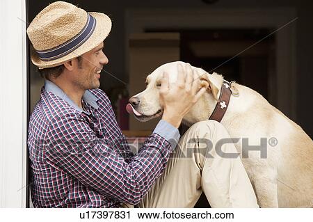 Man petting dog in window View Large Photo Image Stock Image - Man petting dog in window. Fotosearch