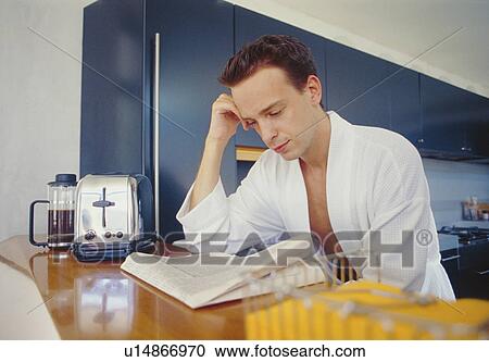 Man reading newspaper in kitchen View Large Photo Image Stock Image - Man reading newspaper in kitchen. Fotosearch