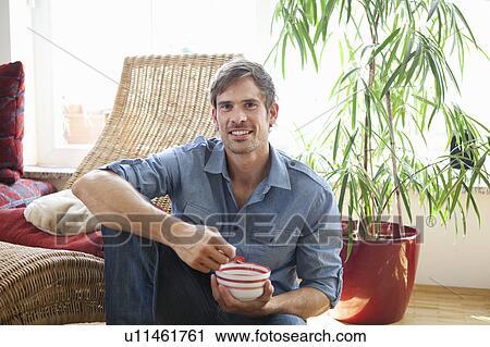 Man relaxing in living room View Large Photo Image Stock Image - Man relaxing in living room. Fotosearch