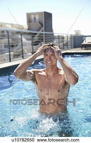 Man relaxing in swimming pool View Large Photo Image Stock Image - Man relaxing in swimming pool. Fotosearch