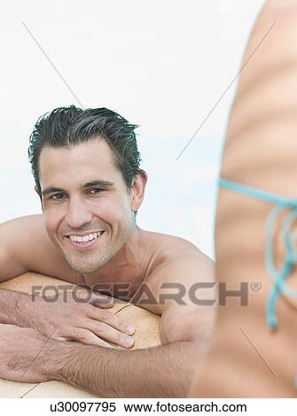 Stock Photography - Man relaxing in swimming pool. Fotosearch