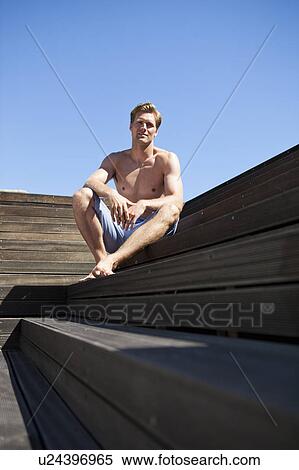 Man relaxing on wooden steps View Large Photo Image Stock Photography - Man relaxing on wooden steps. Fotosearch