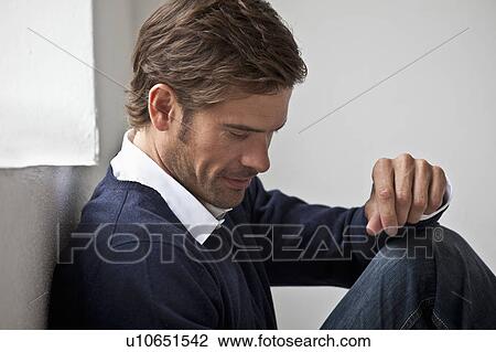 Man sitting on floor View Large Photo Image Stock Image - Man sitting on floor. Fotosearch