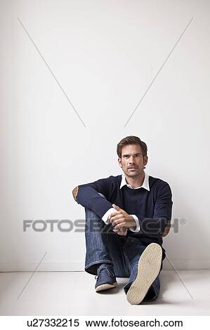 Stock Photography - Man sitting on floor. Fotosearch
