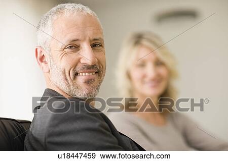 Stock Photo - Man smiling with wife. Fotosearch