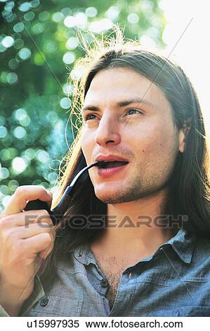 Stock Photography - Man smoking pipe outdoors. Fotosearch