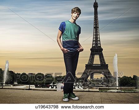 Man standing in front of Eiffel Tower View Large Photo Image Stock Photo - Man standing in front of Eiffel Tower. Fotosearch
