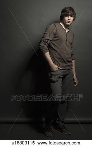 Man standing with hand in pocket View Large Photo Image Stock Photography - Man standing with hand in pocket. Fotosearch