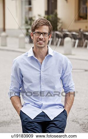Man standing with hands in pockets View Large Photo Image Stock Photo - Man standing with hands in pockets. Fotosearch