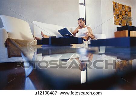 Man studying with laptop in living room View Large Photo Image Stock Photo - Man studying with laptop in living room. Fotosearch