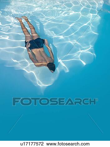 Stock Image - Man swimming in pool. Fotosearch