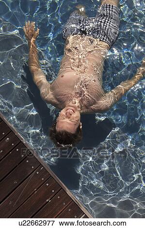 Stock Photo - Man swimming in pool. Fotosearch
