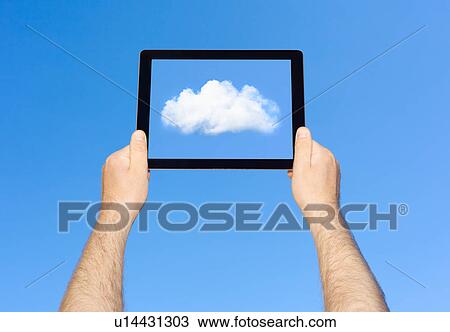 Stock Image - Man viewing cloud on tablet computer . Fotosearch