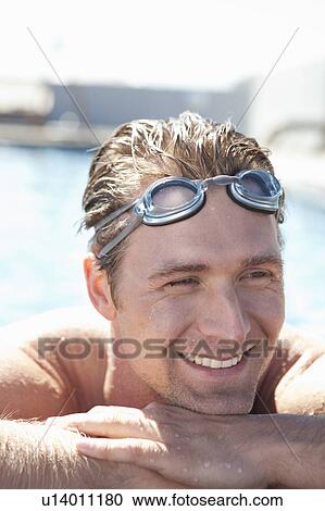 Man wearing goggles in swimming pool View Large Photo Image Stock Image - Man wearing goggles in swimming pool. Fotosearch