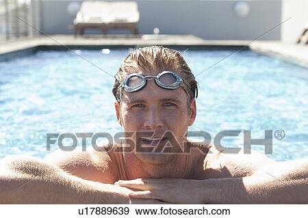 Man wearing goggles in swimming pool View Large Photo Image Stock Photo - Man wearing goggles in swimming pool. Fotosearch