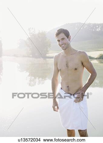 Man wearing towel by lake View Large Photo Image Picture - Man wearing towel by lake. Fotosearch