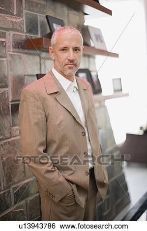 Man wearing trenchcoat in living room View Large Photo Image Stock Photograph - Man wearing trenchcoat in living room. Fotosearch