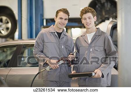 Mechanics working in garage View Large Photo Image Picture - Mechanics working in garage. Fotosearch