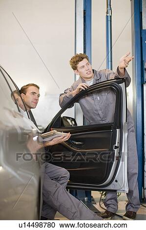 Mechanics working in garage View Large Photo Image Stock Image - Mechanics working in garage. Fotosearch